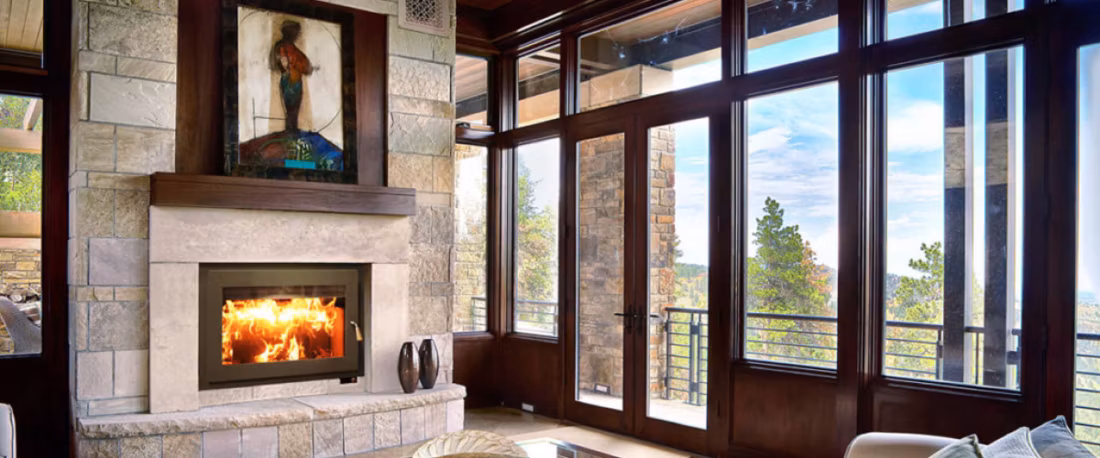 Wood fireplace beside floor-to-ceiling window walls