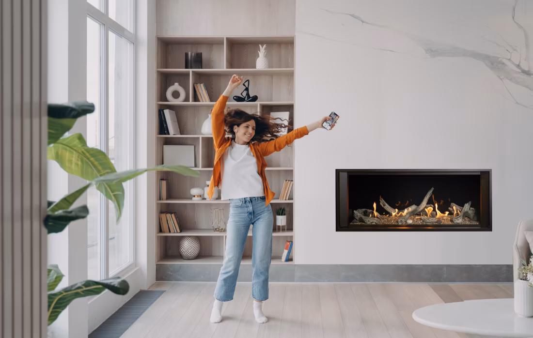 woman dancing with phone in modern living room