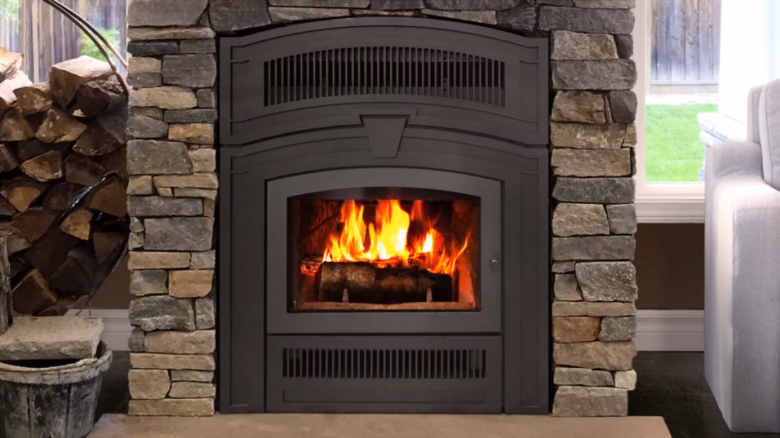 Close-up arched wood fireplace with stacked stone