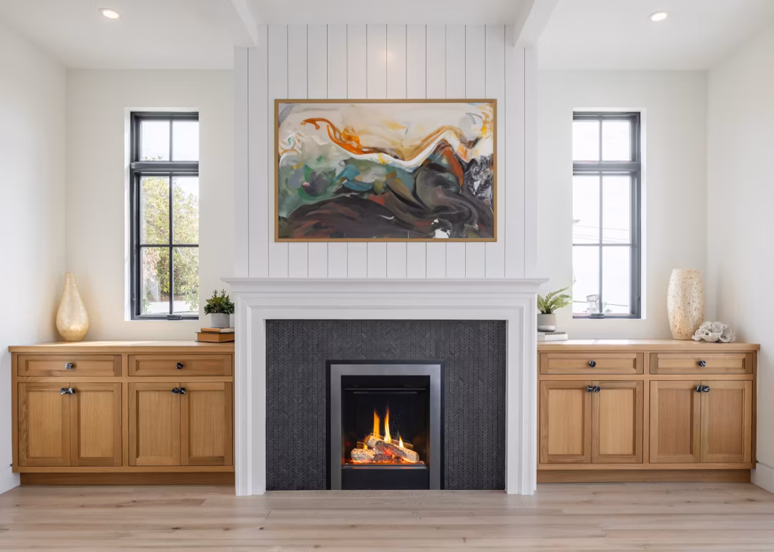 electric fireplace with herringbone tile surround and oak built-ins