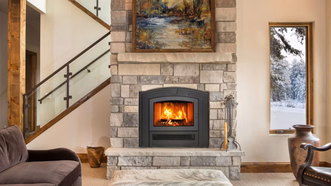Arched wood fireplace in stone beside staircase