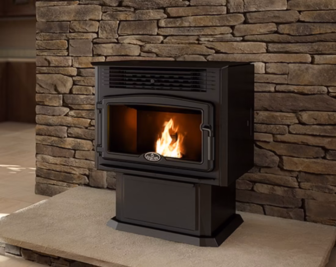 close view of black pellet stove against stacked stone