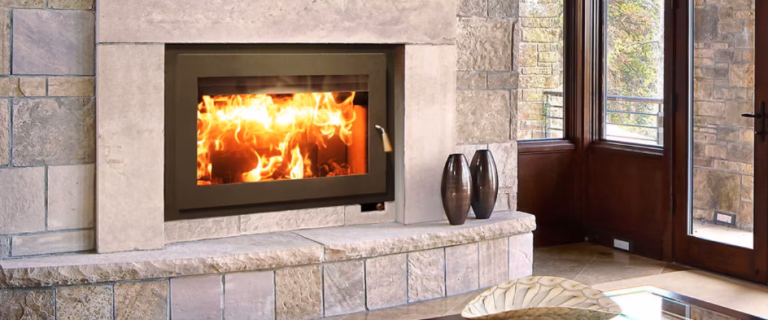 Modern wood fireplace set in limestone surround